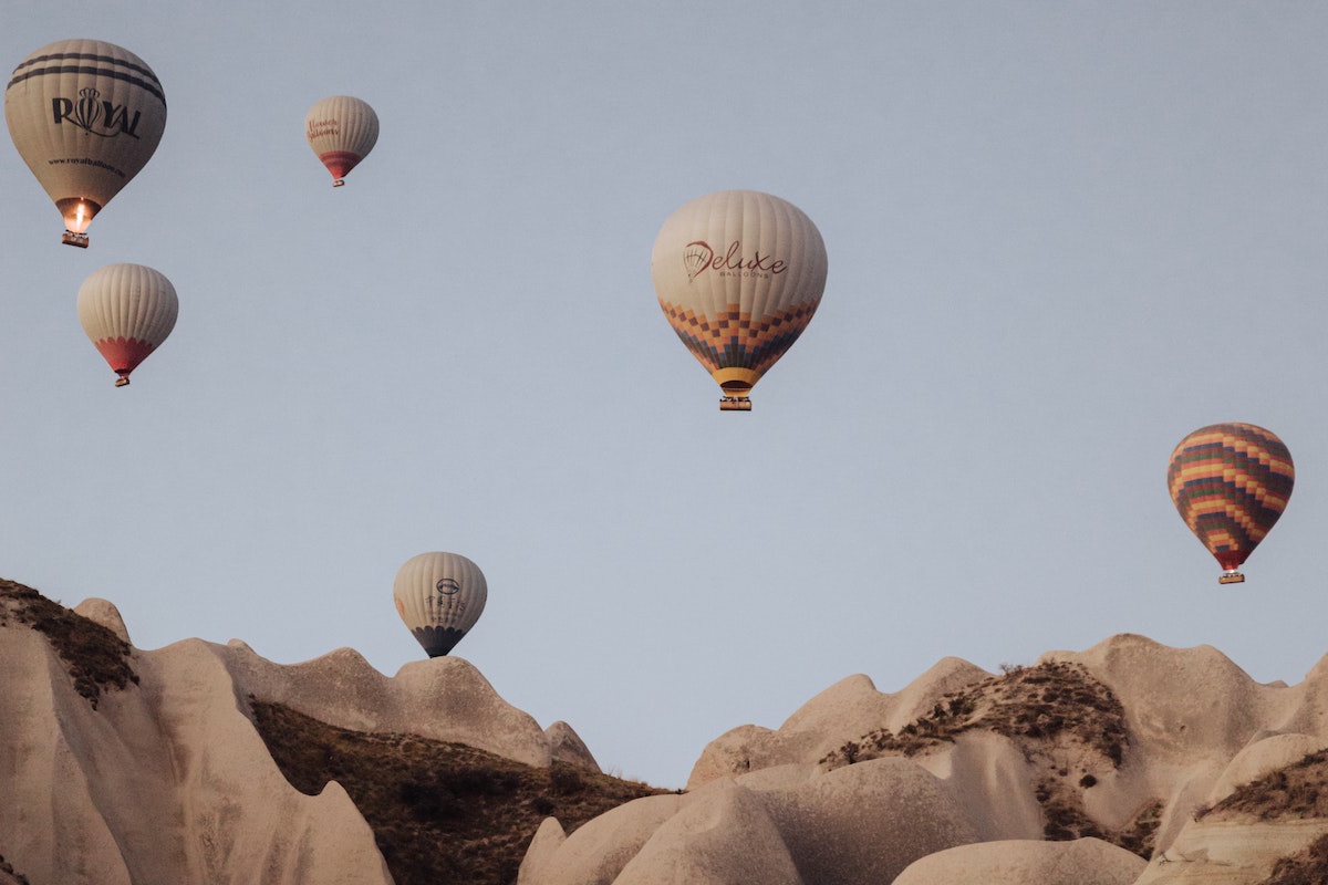 Hot Air Balloons over Hills (Photo by Mesut çiçen)